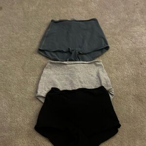 skims boy short in teal, grey, and black